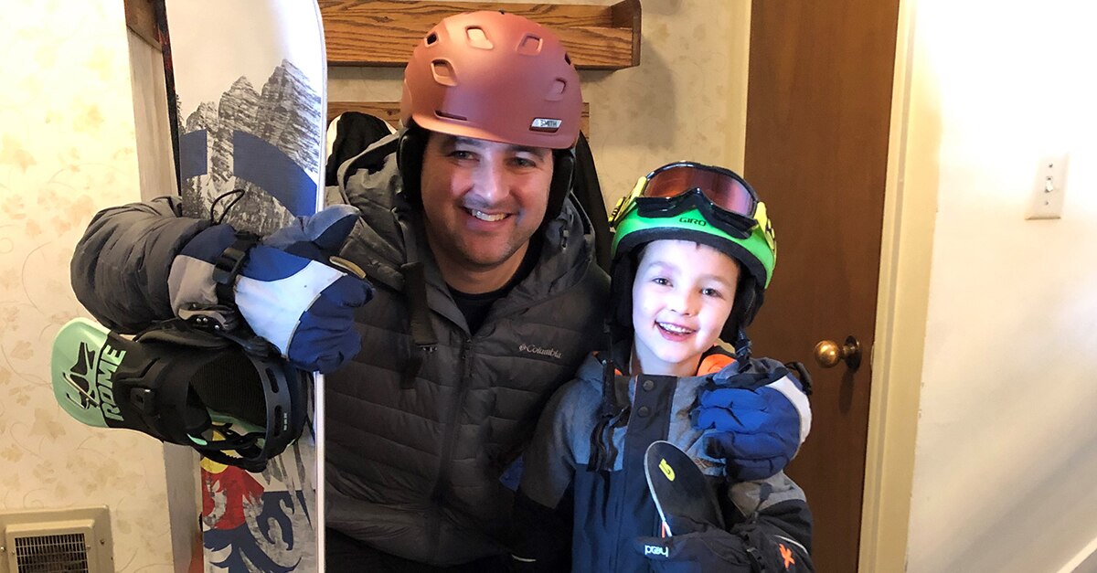 Mike G. snowboarding with his son