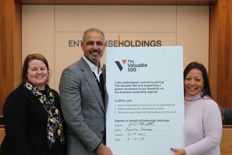 Enterprise Employees holding a Valuable 500 Sign