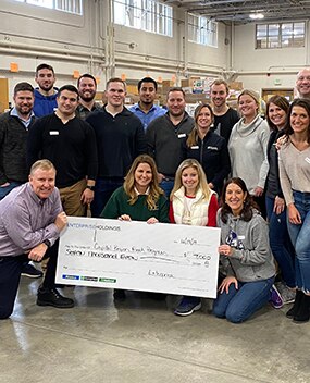 Employee group with donation check