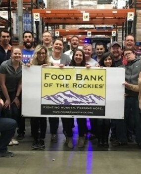 Employee group photo with Food Bank sign