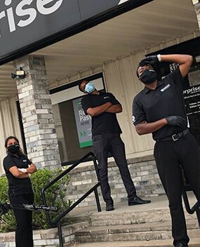 3 employees posing in masks