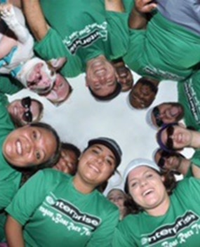 Group of employees in green Enterprise t-shirts taking a selfie