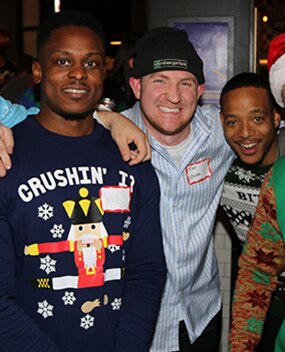 Employees in holiday sweaters