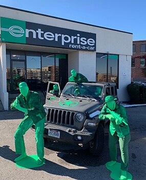 Employees dressed as toy soldiers coming out of a Jeep