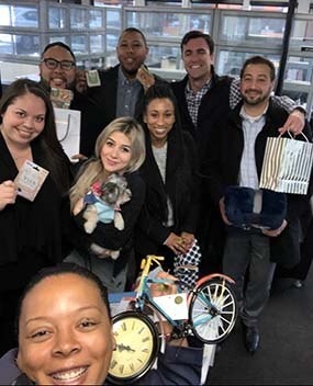 Photo of employees holding gifts