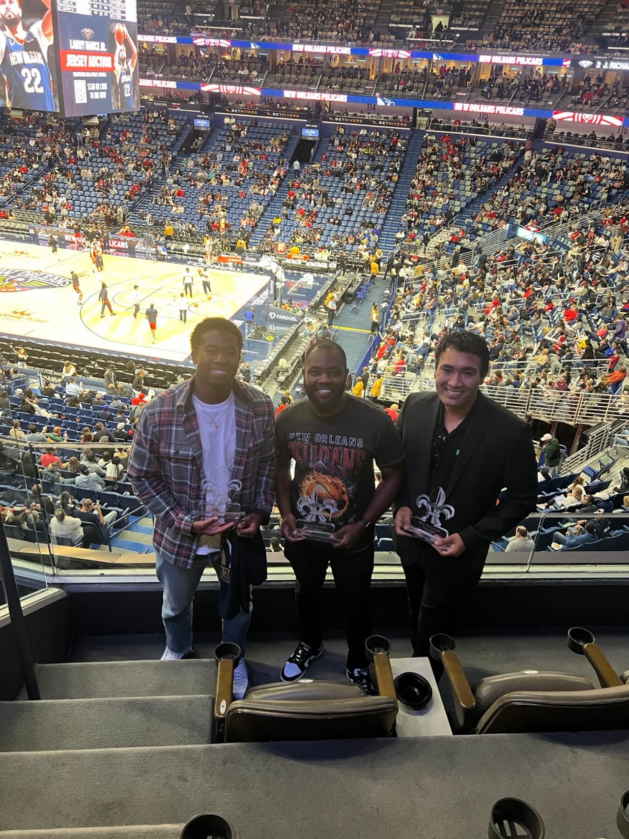 Employee group photo at a basketball game