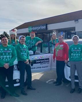 Enterprise employees in holiday sweaters