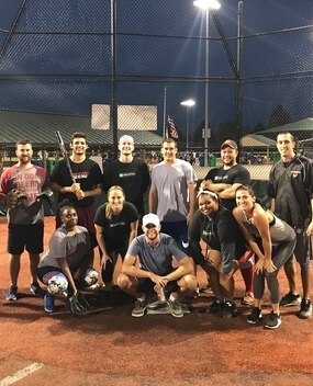 Employee group photo on baseball field