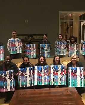 Employee group photo with paintings