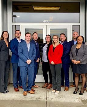 Group of employees in front of a building