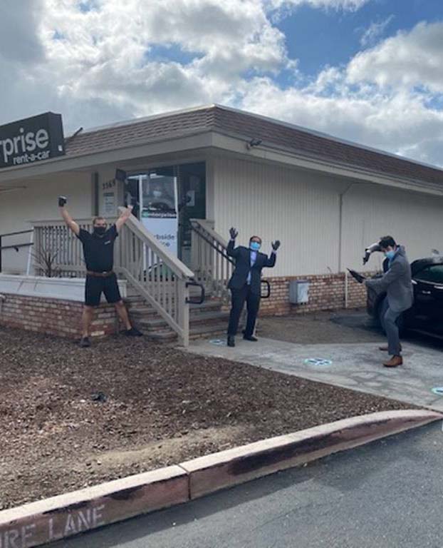 Employees posing outside of the building