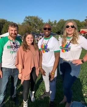 Four employees at an outdoor event