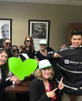 Group photo holding a green heart