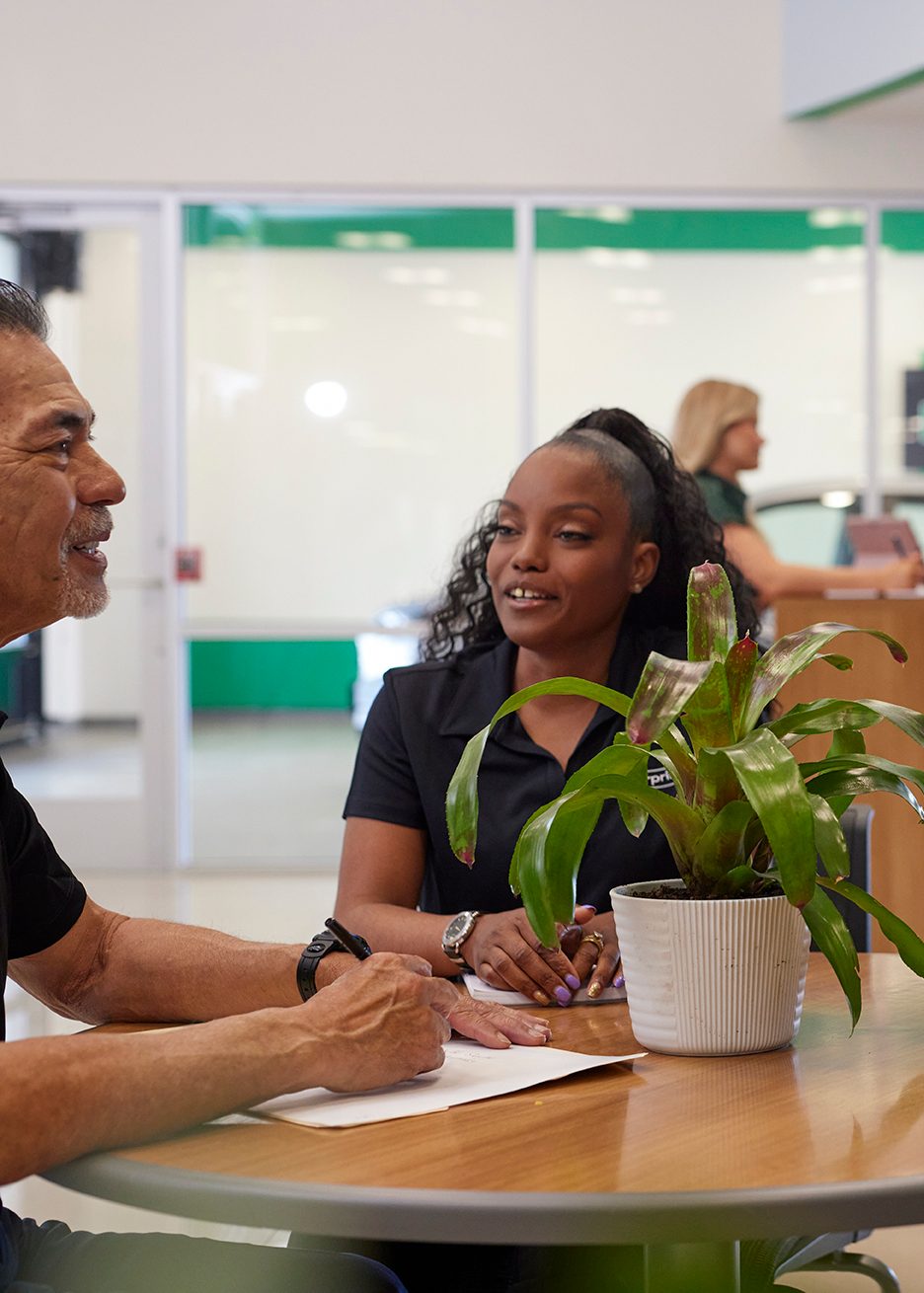 Enterprise Mobility team member sitting at a desk in a local neighborhood retail branch office.