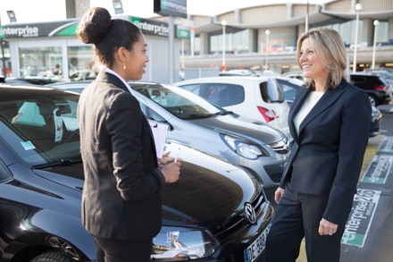 Tori Patrick, Enterprise European Vice President of Airports, and an employee at an Enterprise car lot