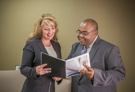 Mentor and mentee reviewing a handbook