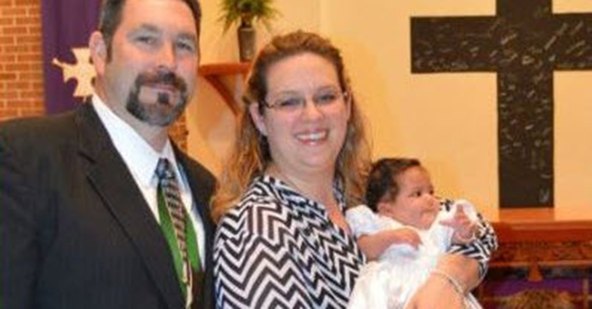 Jennifer with her husband and adopted baby at their baptism