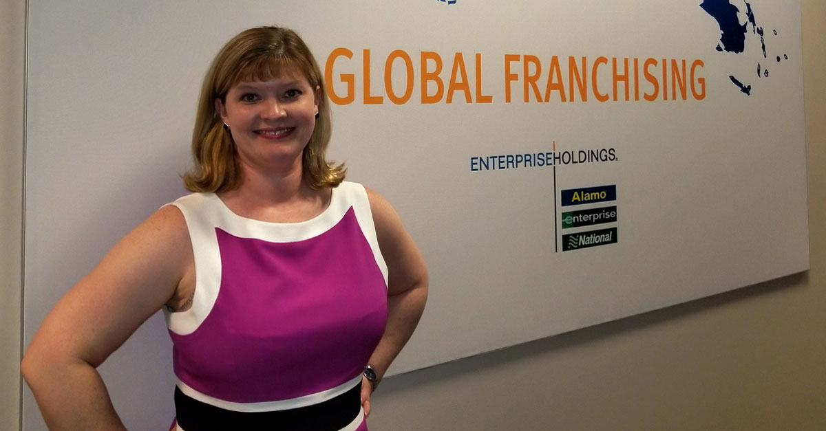 Elizabeth in front of Global Franchising sign