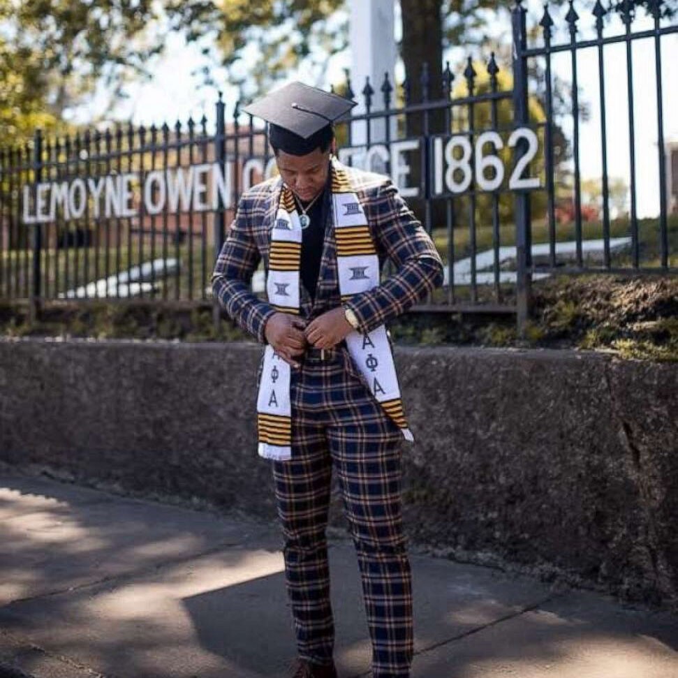 Ty in a plaid suit with graduation cap and stoll