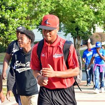 Ty walking with a backpack on