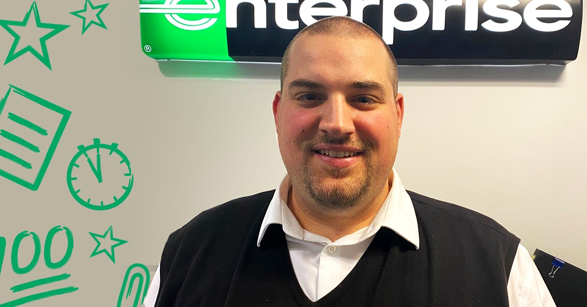 Danny C. in front of Enterprise sign