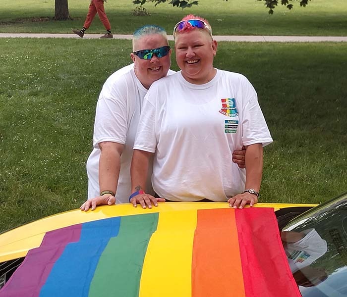 Amy and Ace with a pride flag