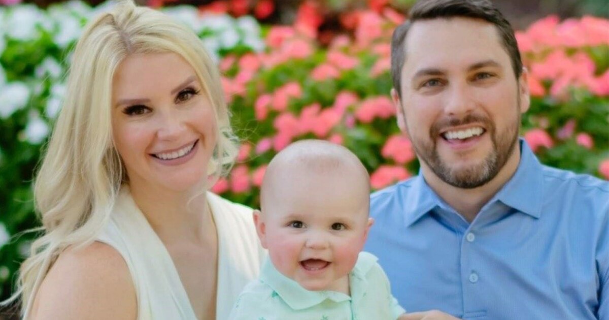 Jen B. family photo with her husband and child in a garden