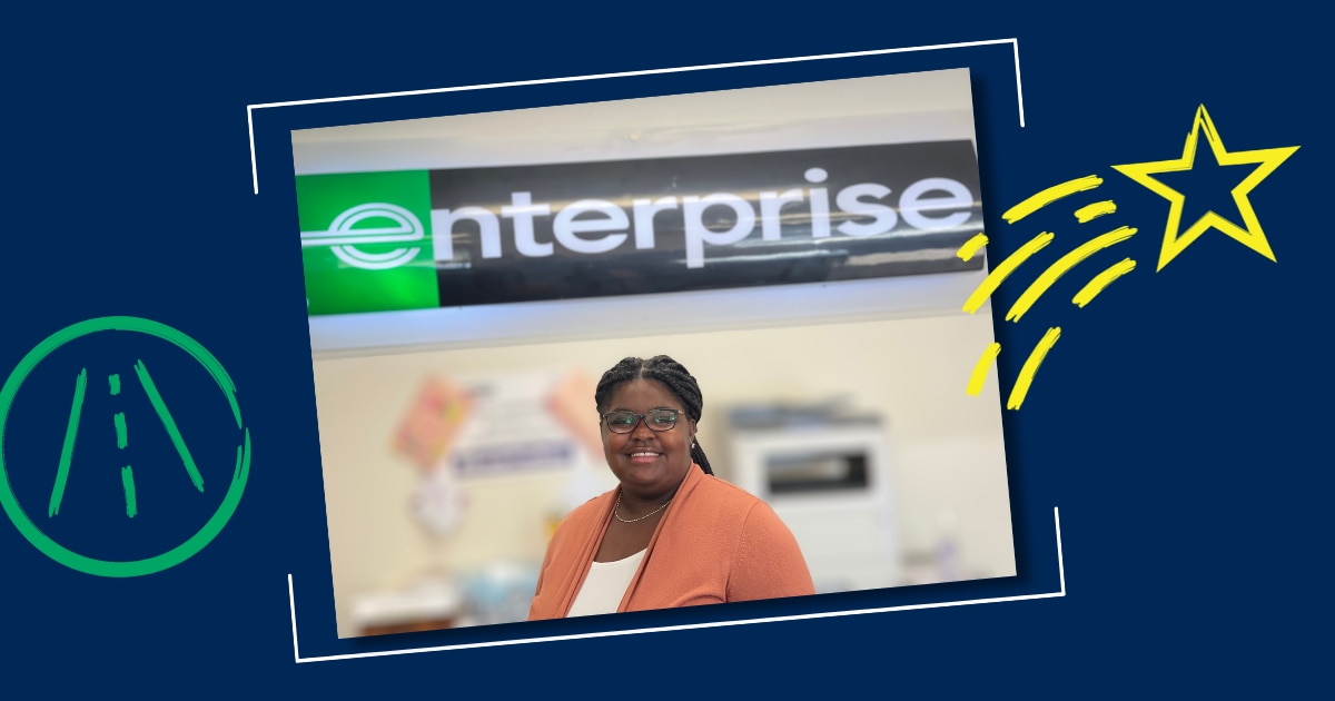 Camille in front of Enterprise Sign