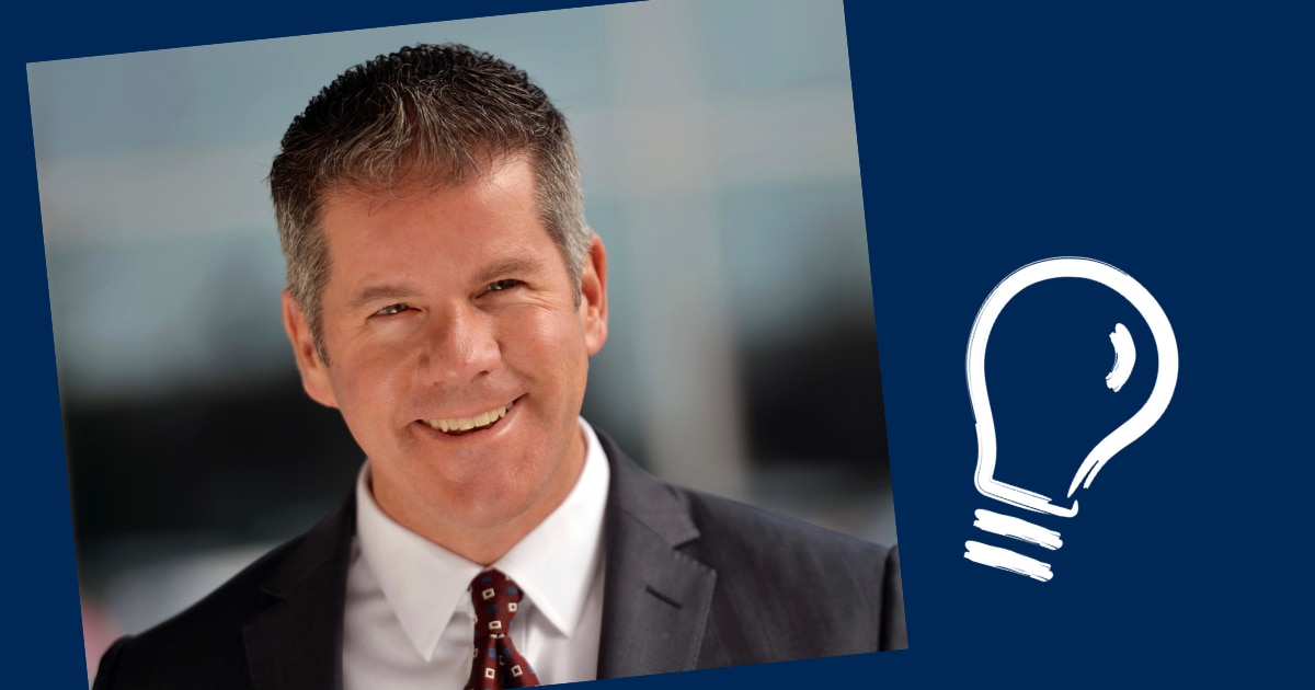 Neil Hafer Headshot on blue background with light bulb icon