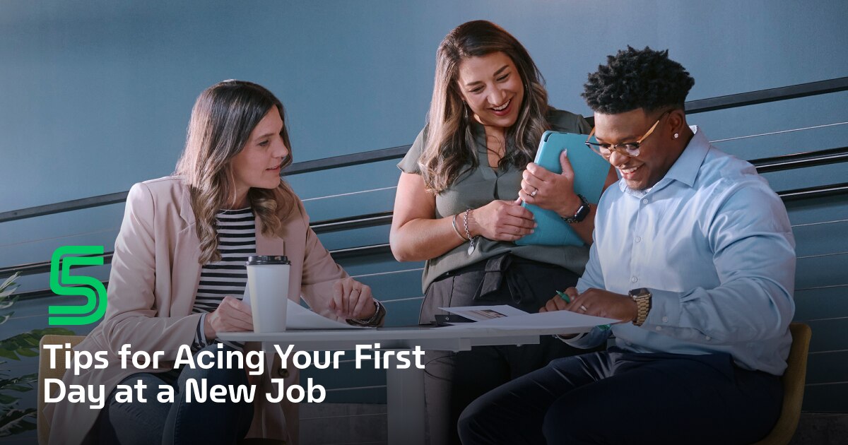 3 employees review paperwork together. Captioned "5 tips for acing your first day at a new job".