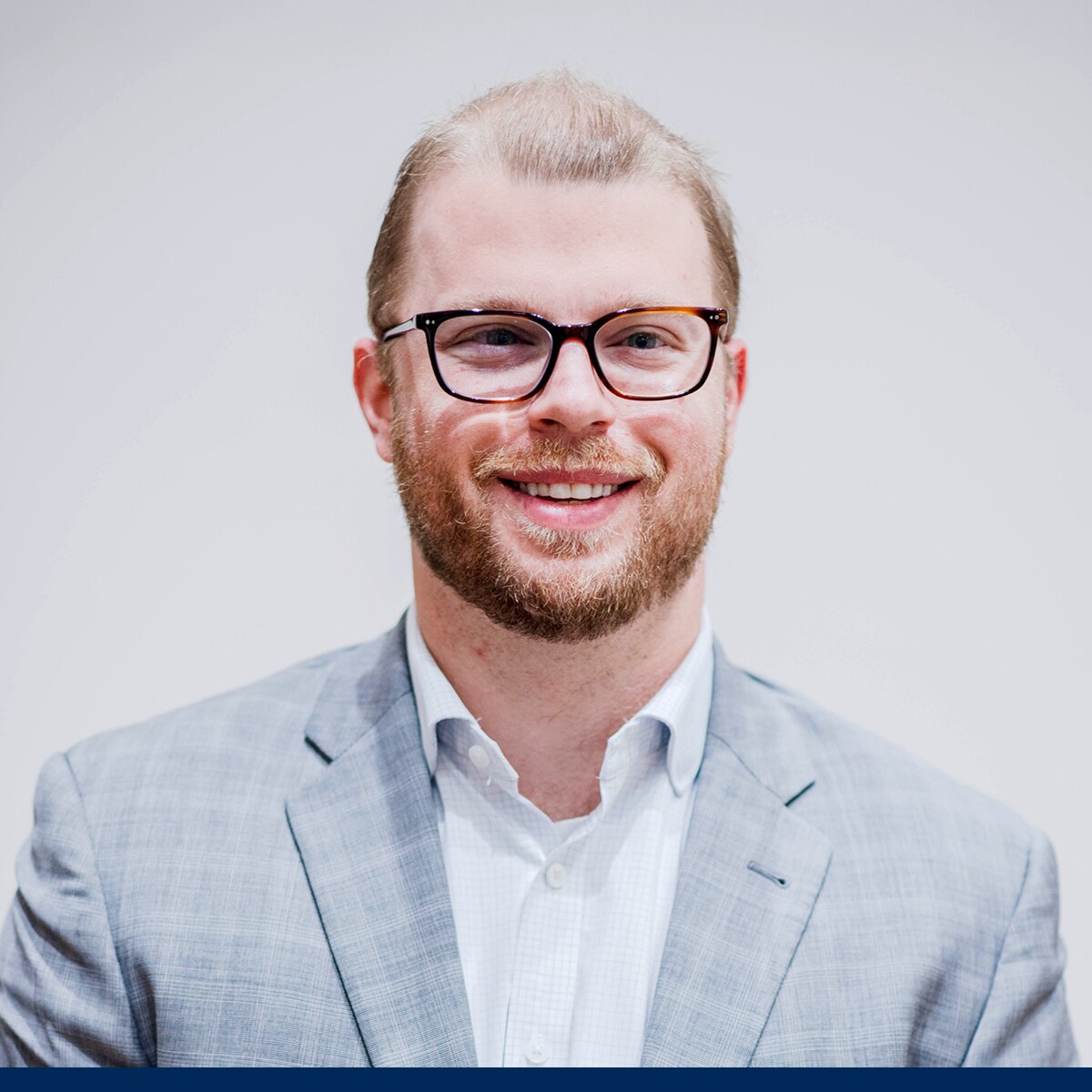 military couple pose for picture in front of plane