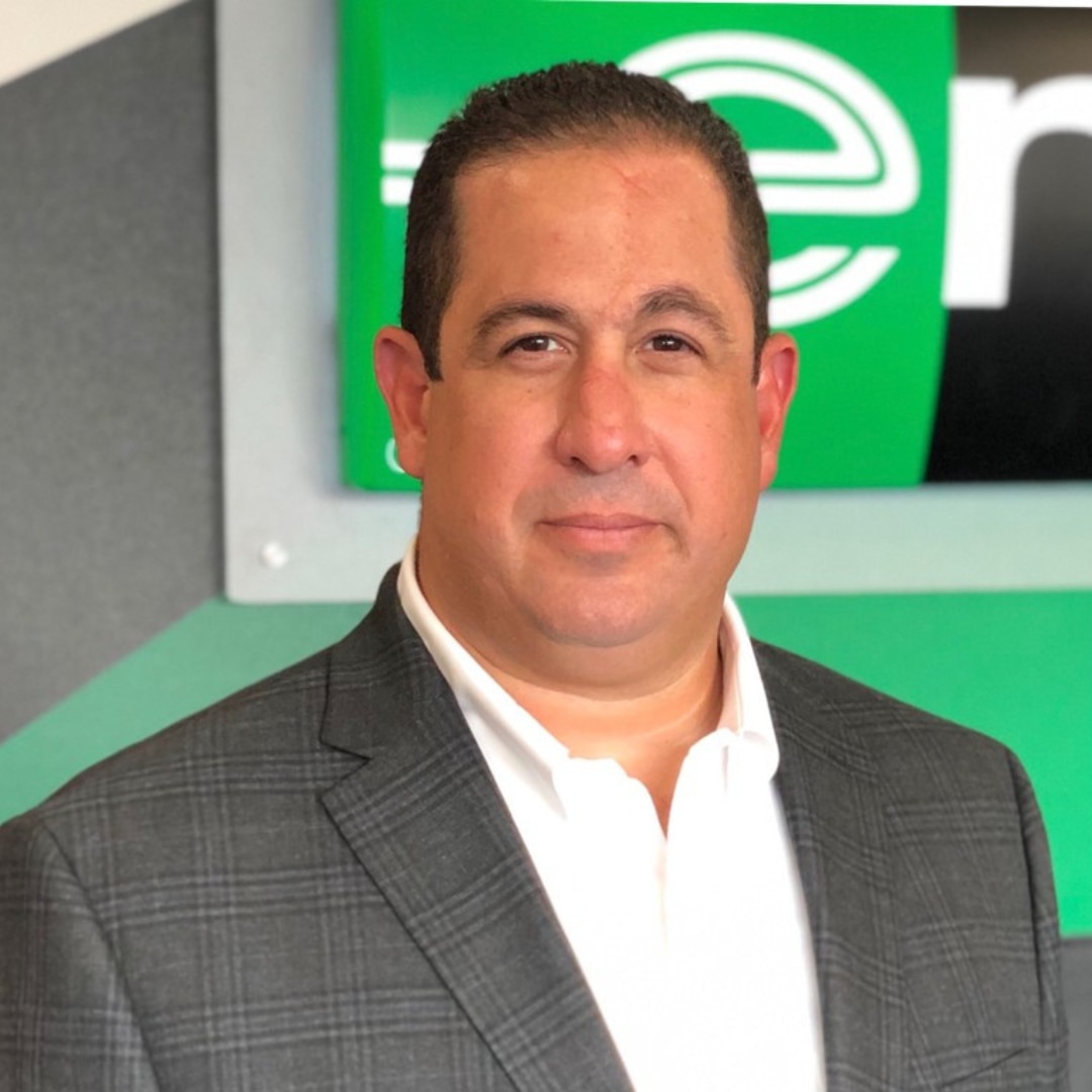 military couple pose for picture in front of plane