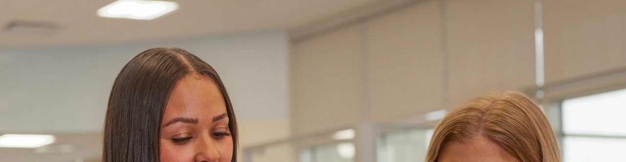 two women at a table in an office