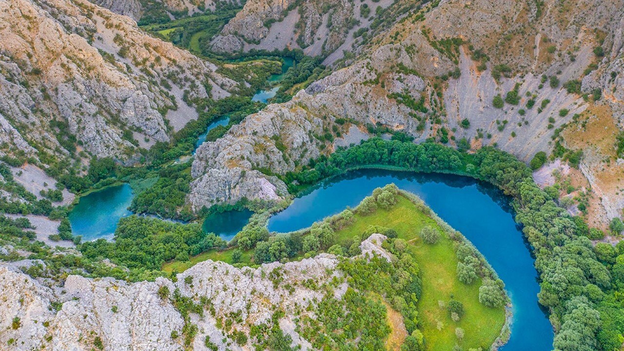 An aerial shot of a river and greenery