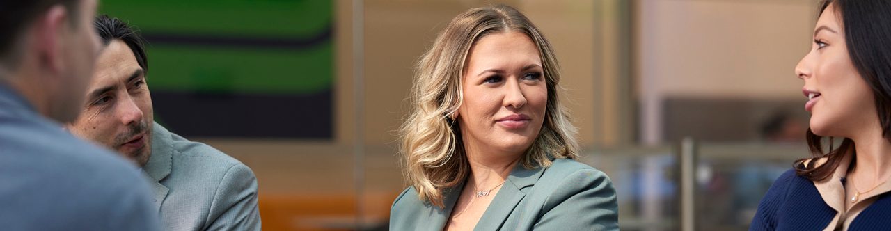 Three Enterprise Mobility team members talking while sitting on a couch in the European head office in Egham, UK 