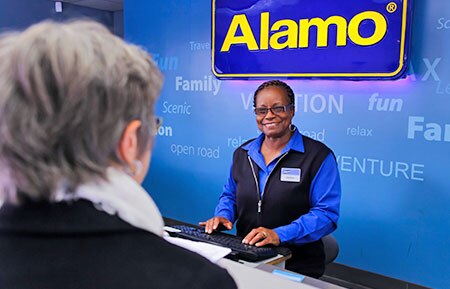 Alamo Customer Service Agent greeting a customer.