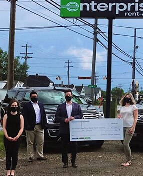 Enterprise Employees posing with a donation check