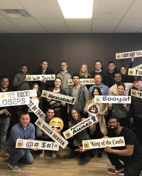 Employees holding signs after an escape room