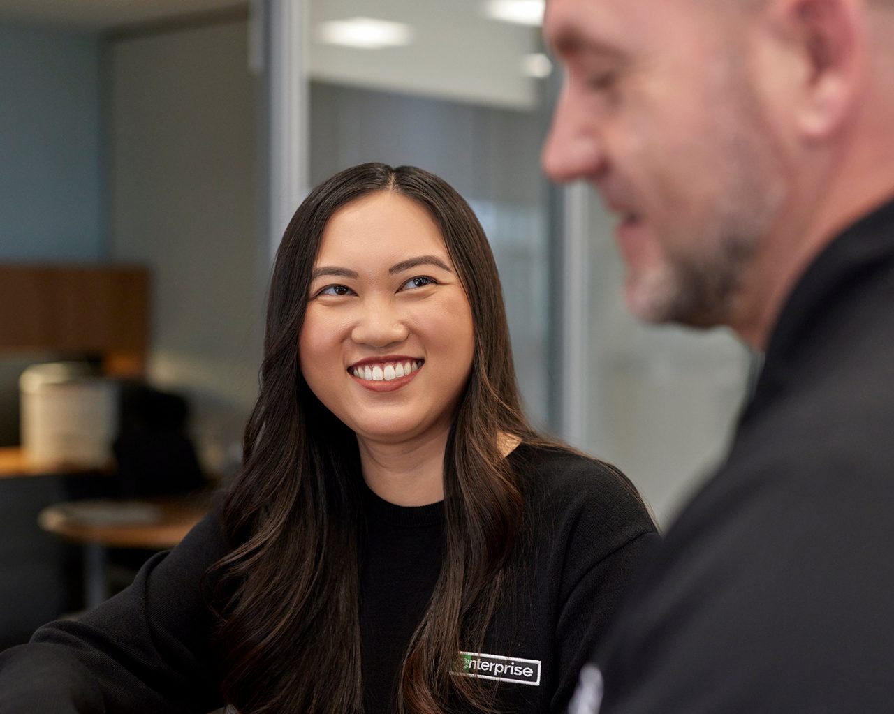 Enterprise Mobility team member looking at another team member at a local neighborhood retail branch office.