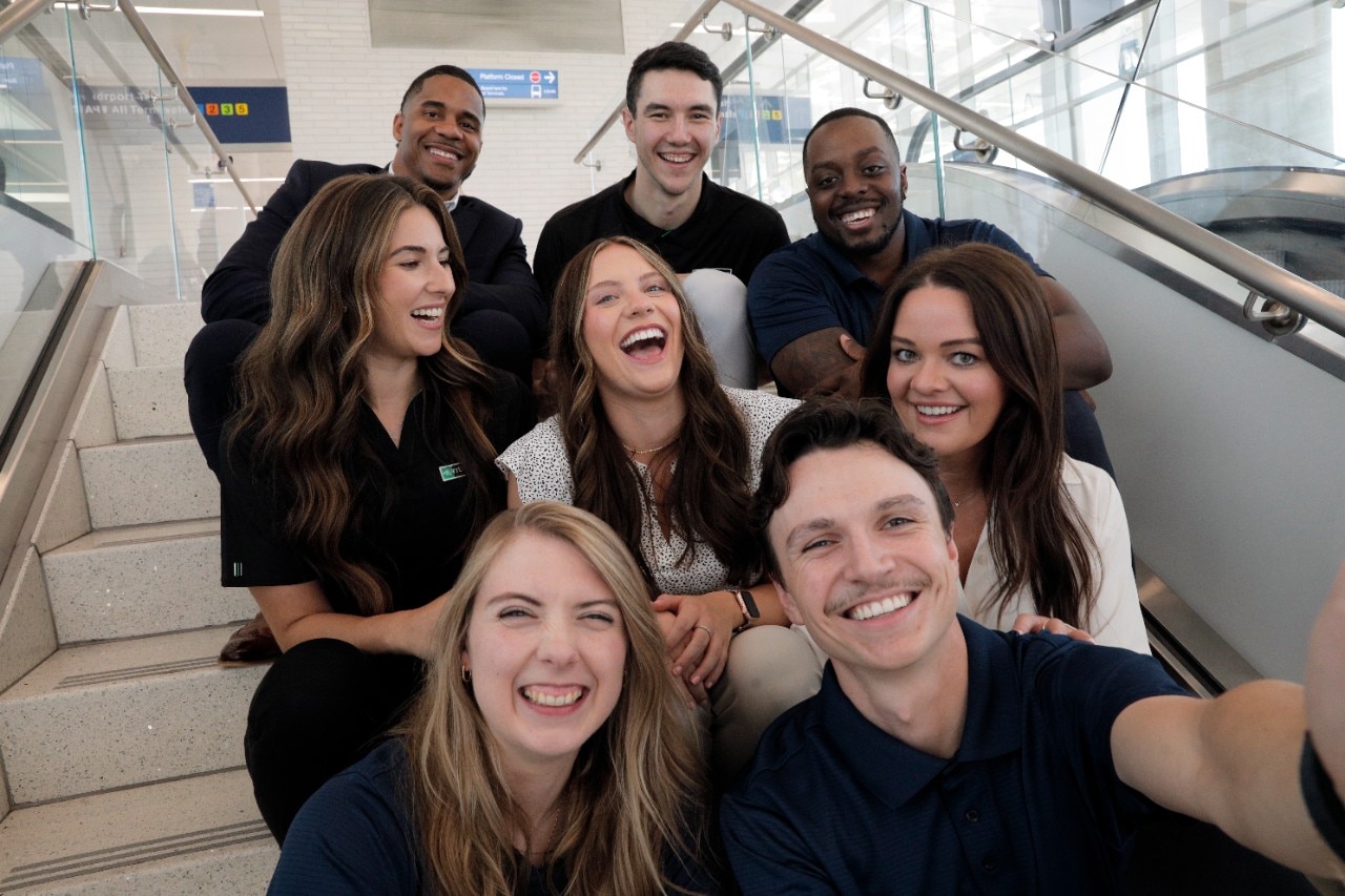 Group of Enterprise Mobility employees talking outside.